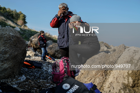 Husband and wife hug each other as a boy cries after their arrival from the Turkish coast to the Greek island of Lesbos Dec. 8, 2015.  