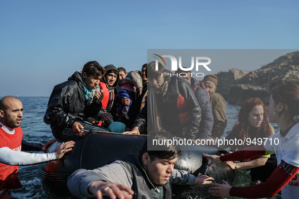 Refugees and migrants arrive on a dingy from the Turkish coast to the northeastern Greek island of Lesbos Dec. 8, 2015. 