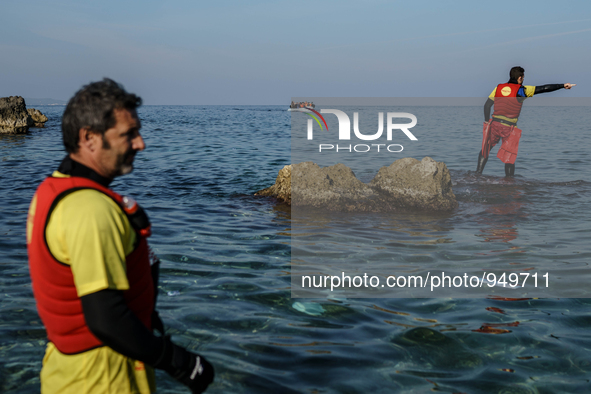 A volunteer goes to help refugees approaching the Greek island of Lesbos on a dinghy after crossing a part of the Aegean sea from the Turkis...