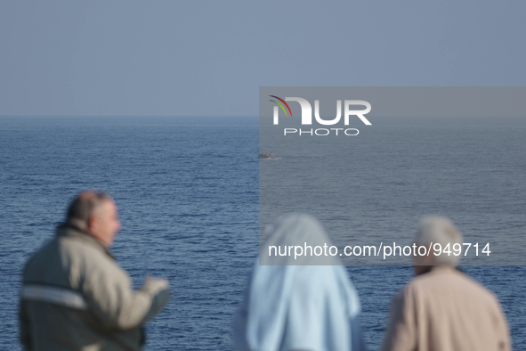 Refugees and migrants arrive on a dingy from the Turkish coast to the northeastern Greek island of Lesbos Dec. 8, 2015. 