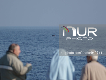 Refugees and migrants arrive on a dingy from the Turkish coast to the northeastern Greek island of Lesbos Dec. 8, 2015. (