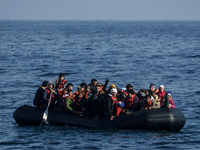 Refugees and migrants arrive on a dingy from the Turkish coast to the northeastern Greek island of Lesbos Dec. 8, 2015. (