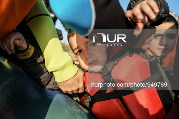 Child is crying when dingy arrived Greek island of Lesbos after crossing the Aegean sea from the Turkish coast, Dec. 8, 2015. 