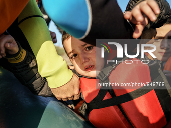 Child is crying when dingy arrived Greek island of Lesbos after crossing the Aegean sea from the Turkish coast, Dec. 8, 2015. (