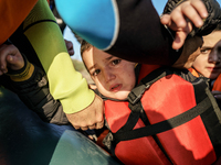 Child is crying when dingy arrived Greek island of Lesbos after crossing the Aegean sea from the Turkish coast, Dec. 8, 2015. (