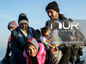 Refugees and migrants aboard a dinghy approach the northeastern Greek island of Lesbos after traveling from the Turkish coast  Dec. 8, 2015....