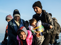 Refugees and migrants aboard a dinghy approach the northeastern Greek island of Lesbos after traveling from the Turkish coast  Dec. 8, 2015....