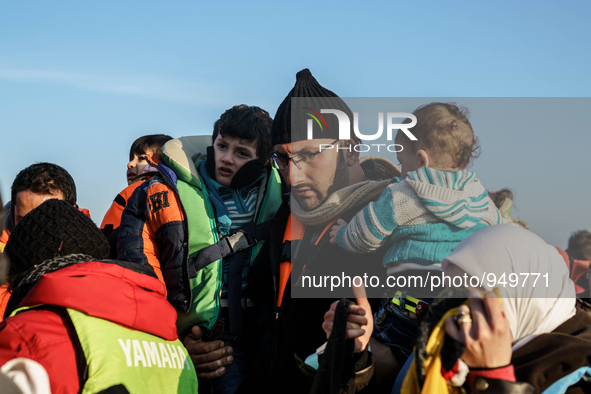 Refugees and migrants aboard a dinghy approach the northeastern Greek island of Lesbos after traveling from the Turkish coast  Dec. 8, 2015....