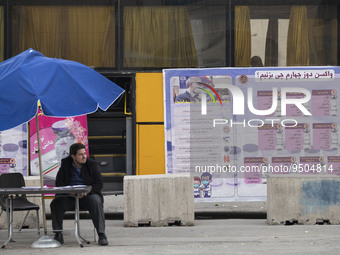 A staff member of the Baqiyatallah hospital sits in front of a new coronavirus disease (COVID-19) mobile vaccination station during Tehran's...