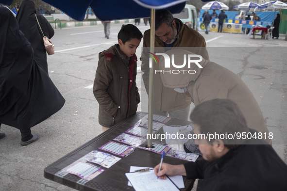 An Iranian worshipper and his son register to receive a dose of the Iranian Noora new coronavirus disease (COVID-19) vaccine out of a COVID-...