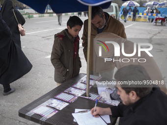 An Iranian worshipper and his son register to receive a dose of the Iranian Noora new coronavirus disease (COVID-19) vaccine out of a COVID-...