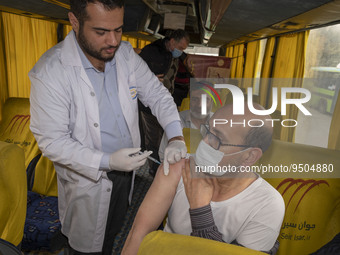 An Iranian worshipper wearing a protective face mask receives a dose of the Iranian Noora new coronavirus disease (COVID-19) vaccine at a mo...