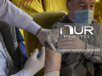 An Iranian worshipper wearing a protective face mask receives a dose of the Iranian Noora new coronavirus disease (COVID-19) vaccine at a mo...