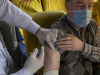 An Iranian worshipper wearing a protective face mask receives a dose of the Iranian Noora new coronavirus disease (COVID-19) vaccine at a mo...