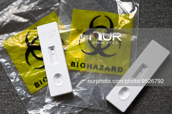 COVID-19 rapid antigen tests and plastic bags with 'biohazard' sign are seen in this illustration photo taken in Krakow, Poland on January 3...