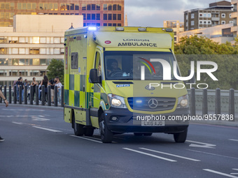 Yellow ambulance spotted on Westminster Bridge, an emergency service vehicle with paramedics of the National Health Service NHS in motion on...