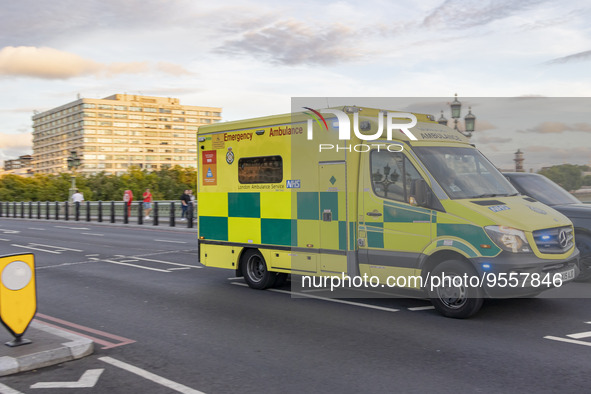 Yellow ambulance spotted on Westminster Bridge, an emergency service vehicle with paramedics of the National Health Service NHS in motion on...