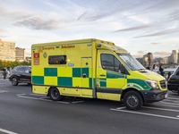 Yellow ambulance spotted on Westminster Bridge, an emergency service vehicle with paramedics of the National Health Service NHS in motion on...