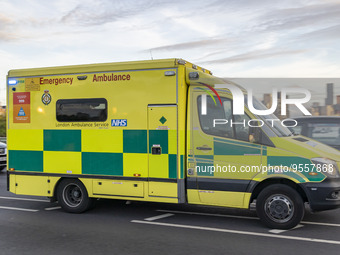 Yellow ambulance spotted on Westminster Bridge, an emergency service vehicle with paramedics of the National Health Service NHS in motion on...