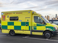 Yellow ambulance spotted on Westminster Bridge, an emergency service vehicle with paramedics of the National Health Service NHS in motion on...