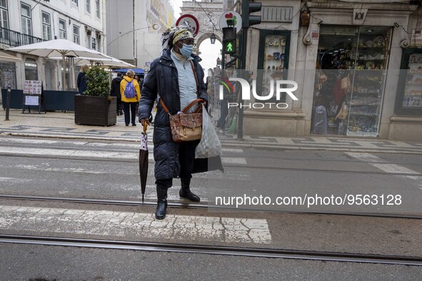 A woman wearing protective mask is seen walking along one of the streets in the Baixa district. Lisbon, January 23, 2023. In Portugal, the t...