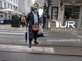 A woman wearing protective mask is seen walking along one of the streets in the Baixa district. Lisbon, January 23, 2023. In Portugal, the t...