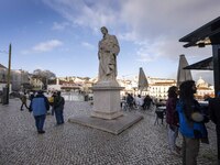 People are seen walking along one of the viewpoints located in the historic district of Graca. Lisbon, January 23, 2023. In Portugal, the tr...