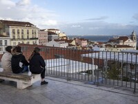 Several people are seen touring a viewpoint located in the Santa Apolonia neighborhood. Lisbon, January 16, 2023. In Portugal, the transmiss...