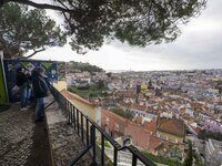 Several people are seen sitting at a viewpoint located in the Graca neighborhood. Lisbon, January 16, 2023. In Portugal, the transmissibilit...