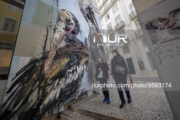 People using protective mask are seen walking along one of the streets in the Baixa district. Lisbon, January 23, 2023. In Portugal, the tra...