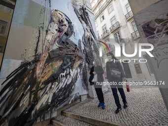 People using protective mask are seen walking along one of the streets in the Baixa district. Lisbon, January 23, 2023. In Portugal, the tra...