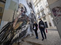 People using protective mask are seen walking along one of the streets in the Baixa district. Lisbon, January 23, 2023. In Portugal, the tra...