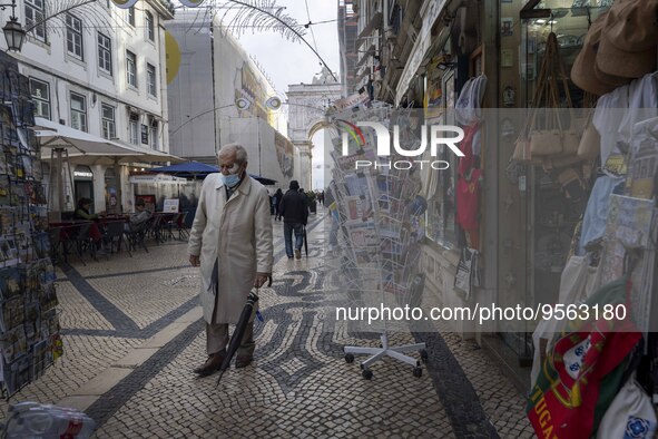 A man using protective mask is seen walking along one of the streets in the Baixa district. Lisbon, January 23, 2023. In Portugal, the trans...