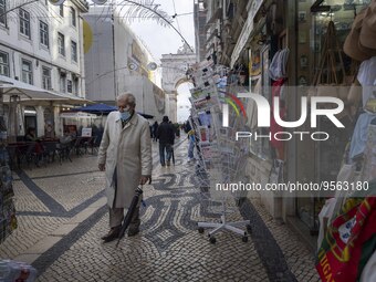 A man using protective mask is seen walking along one of the streets in the Baixa district. Lisbon, January 23, 2023. In Portugal, the trans...