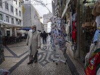 A man using protective mask is seen walking along one of the streets in the Baixa district. Lisbon, January 23, 2023. In Portugal, the trans...