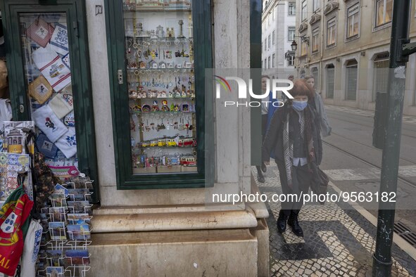 People using protective mask are seen walking along one of the streets in the Baixa district. Lisbon, January 23, 2023. In Portugal, the tra...