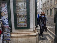 People using protective mask are seen walking along one of the streets in the Baixa district. Lisbon, January 23, 2023. In Portugal, the tra...