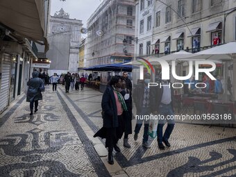 People using protective mask are seen walking along one of the streets in the Baixa district. Lisbon, January 23, 2023. In Portugal, the tra...