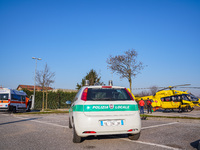 Police car and Medical helicopter landed in the background in a public car parking , in Cernusco sul Naviglio, Italy, on February 10, 2023....