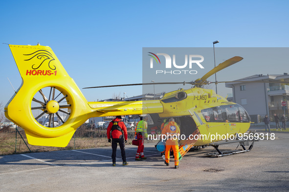 Injured person on the stretcher enters in the Medical helicopter landed in a public car parking , in Cernusco sul Naviglio, Italy, on Februa...