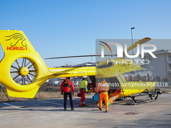 Injured person on the stretcher enters in the Medical helicopter landed in a public car parking , in Cernusco sul Naviglio, Italy, on Februa...