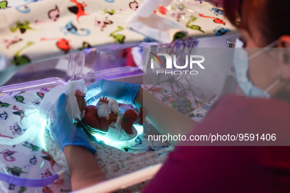 A nurse is taking care of one of the quintuplets laying in an incubator. Krakow, Poland on February 14, 2023. Three girls and two boys were...