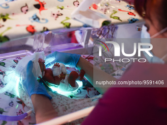 A nurse is taking care of one of the quintuplets laying in an incubator. Krakow, Poland on February 14, 2023. Three girls and two boys were...