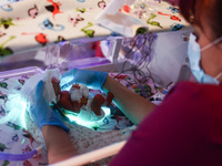 A nurse is taking care of one of the quintuplets laying in an incubator. Krakow, Poland on February 14, 2023. Three girls and two boys were...