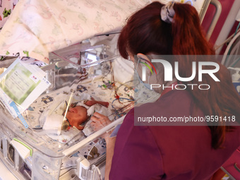 A nurse is taking care of one of the quintuplets laying in an incubator. Krakow, Poland on February 14, 2023. Three girls and two boys were...