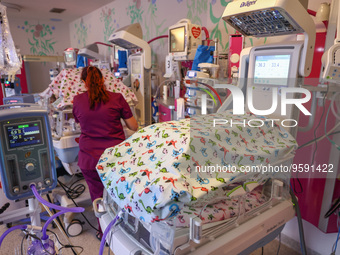 A nurse is taking care of the quintuplets laying in an incubator. Krakow, Poland on February 14, 2023. Three girls and two boys were born in...