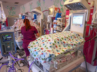 A nurse is taking care of the quintuplets laying in an incubator. Krakow, Poland on February 14, 2023. Three girls and two boys were born in...