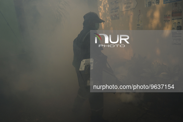 A Thai health officer sprays chemicals to kill mosquitos for the health precaution against dengue fever inside a community in Bangkok, Thail...