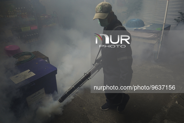 A Thai health officer sprays chemicals to kill mosquitos for the health precaution against dengue fever inside a community in Bangkok, Thail...