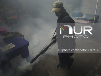 A Thai health officer sprays chemicals to kill mosquitos for the health precaution against dengue fever inside a community in Bangkok, Thail...